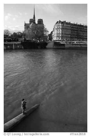 Fishing in the Seine river, Notre Dame Cathedral in the background. Paris, France (black and white)