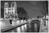 Facade of Notre Dame and Seine river at night. Paris, France ( black and white)