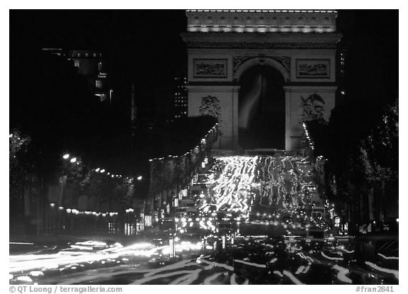 Arc de Triomphe and Champs Elysees at night with car light trails. Paris, France (black and white)