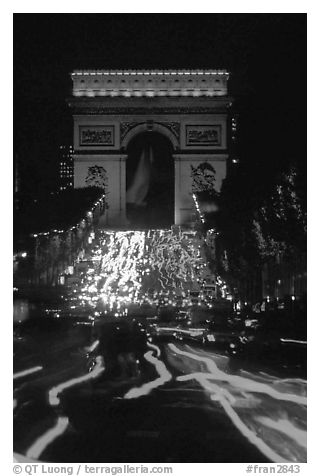 Arc de Triomphe and lights of cars on Champs Elysees. Paris, France (black and white)