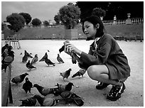 Girl feeding pigeon, Jardin du Luxembourg. Quartier Latin, Paris, France (black and white)