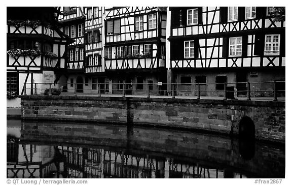 Half-timbered houses reflected in canal. Strasbourg, Alsace, France (black and white)