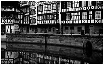 Half-timbered houses reflected in canal. Strasbourg, Alsace, France (black and white)