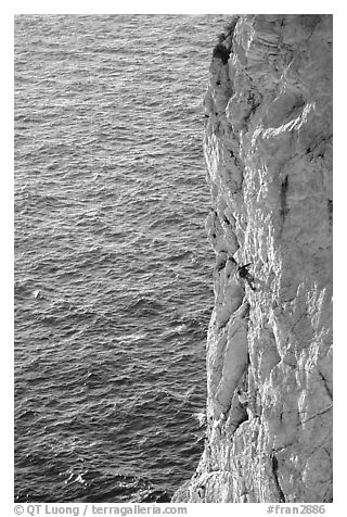 Rock climbing above water in the Calanque de Morgiou. Marseille, France (black and white)