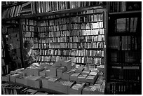 Checking a book in Shakespeare and Company bookstore. Quartier Latin, Paris, France ( black and white)
