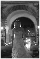 Woman in bridal gown in front of the Louvre by night. Paris, France (black and white)