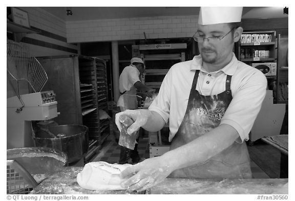 Baker preparing a loaf of break. Paris, France