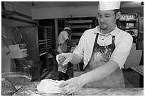 Baker preparing a loaf of break. Paris, France ( black and white)