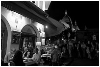 Outdoor restaurant at night on the Place du Tertre, Montmartre. Paris, France (black and white)