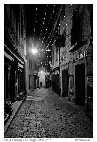 Medieval street by night with Christmas decorations and. Carcassonne, France (black and white)