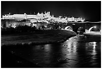 Fortified city and Pont Vieux crossing the Aude River by night. Carcassonne, France ( black and white)