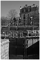 Pedestrians walking on brige above Canal du Midi. Carcassonne, France ( black and white)