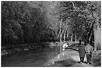 Couple walking along Canal du Midi. Carcassonne, France (black and white)