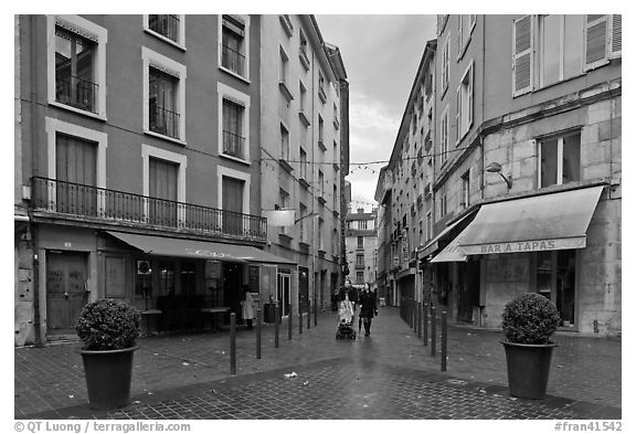 Pedestrian street with couple pushing stroller. Grenoble, France (black and white)