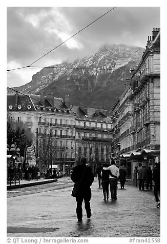 Downtown street and snowy mountains of the Belledone Range. Grenoble, France (black and white)