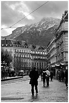 Downtown street and snowy mountains of the Belledone Range. Grenoble, France (black and white)