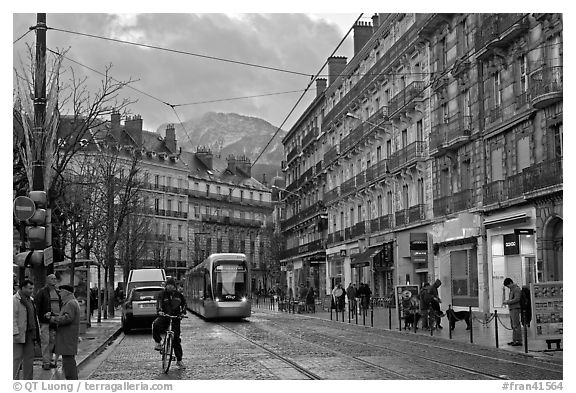 Bicyclist and tramway next to Victor Hugo place. Grenoble, France