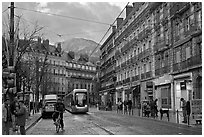 Bicyclist and tramway next to Victor Hugo place. Grenoble, France (black and white)