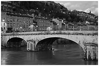 Bridge and brightly painted riverside houses at dusk. Grenoble, France (black and white)