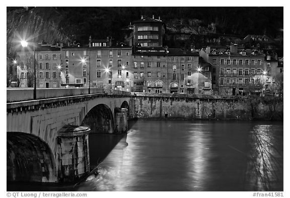 Isere River, Citadelle stone bridge and old houses at dusk. Grenoble, France (black and white)