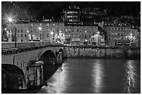 Isere River, Citadelle stone bridge and old houses at dusk. Grenoble, France (black and white)