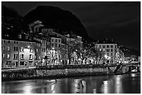Isere River and houses below the Citadelle at night. Grenoble, France (black and white)