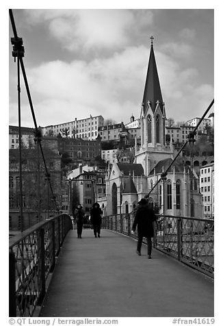 Walking across the passerelle Saint-Georges. Lyon, France (black and white)