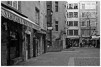 Square with restaurant offering the local specialty bouchon lyonnais. Lyon, France (black and white)