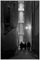 Silhouettes in staircase on Fourviere Hill at dusk. Lyon, France (black and white)