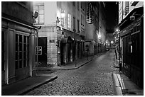 Narrow cobblestone street in historic district at night. Lyon, France ( black and white)