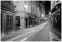 Street with light trails left by cars. Lyon, France (black and white)