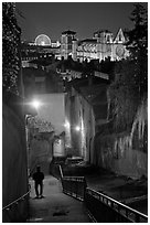 Man walking down stairs from Fourviere Hill, with St-Jean Cathedral below. Lyon, France (black and white)