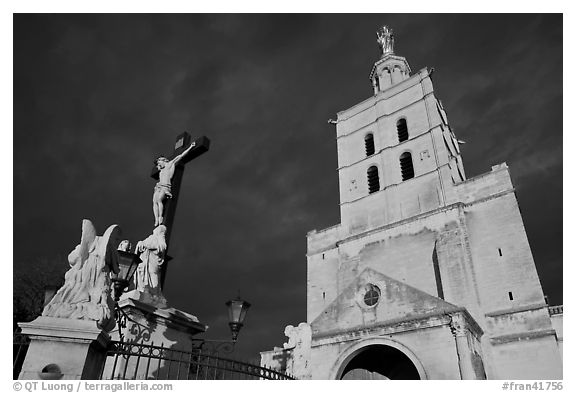 Crucifix and romanesque tower of Notre-Dame-des-Doms Cathedral. Avignon, Provence, France (black and white)