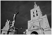 Crucifix and romanesque tower of Notre-Dame-des-Doms Cathedral. Avignon, Provence, France (black and white)