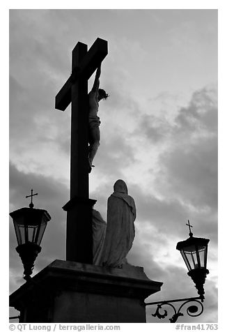 Cross with Christ at sunset. Avignon, Provence, France (black and white)