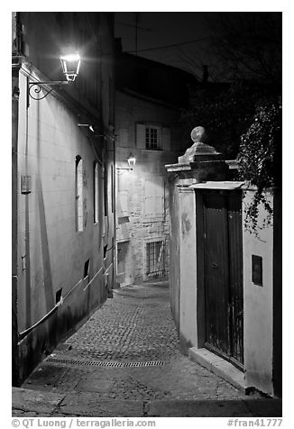 Narrow cobblestone street and street light. Avignon, Provence, France