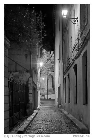 Narrow street leading to Palais des Papes at night. Avignon, Provence, France