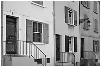 Facade of townhouses with colorful shutters. Arles, Provence, France ( black and white)