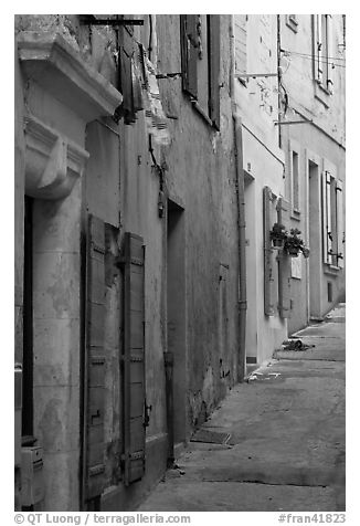 Painted facades in narrow street. Arles, Provence, France