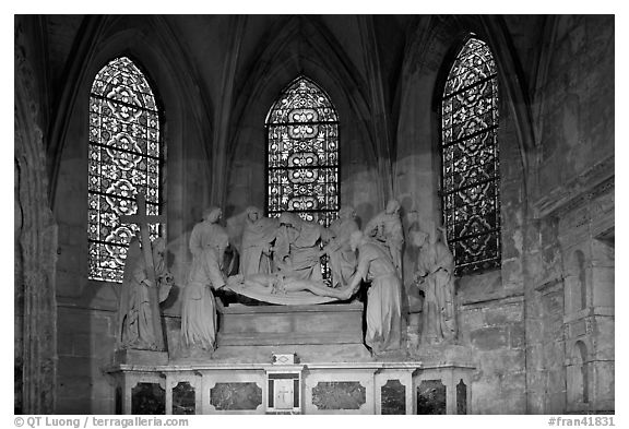 Christ sculpture and stained glass windows, St Trophime church. Arles, Provence, France (black and white)