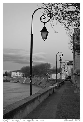 Walkway on the banks of the Rhone River at dusk. Arles, Provence, France (black and white)