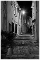 Cobblestone passageway with stepts at night. Arles, Provence, France (black and white)