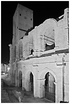 Arenes Roman amphitheater with defensive tower at night. Arles, Provence, France (black and white)