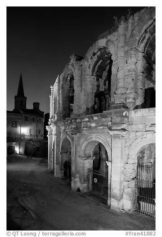 Roman arenes and church at night. Arles, Provence, France