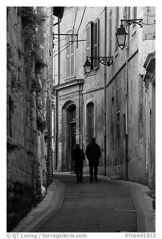 Couple walking in old street. Arles, Provence, France (black and white)