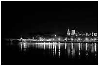 Avignon skyline at night with lights reflected in Rhone River. Avignon, Provence, France (black and white)