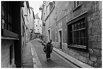 Boy walking in narrow street, Chartres. France (black and white)