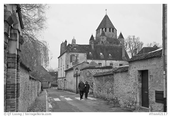 Street with couple walking and Caesar's Tower in background, Provins. France (black and white)