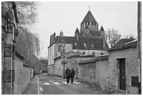 Street with couple walking and Caesar's Tower in background, Provins. France (black and white)