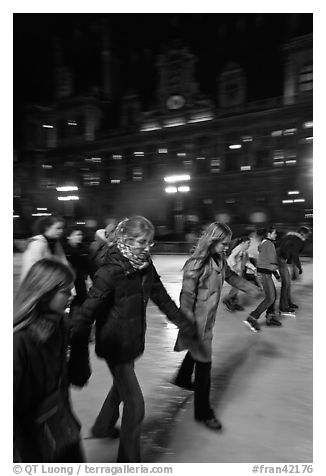 Girls skating by night, Hotel de Ville. Paris, France